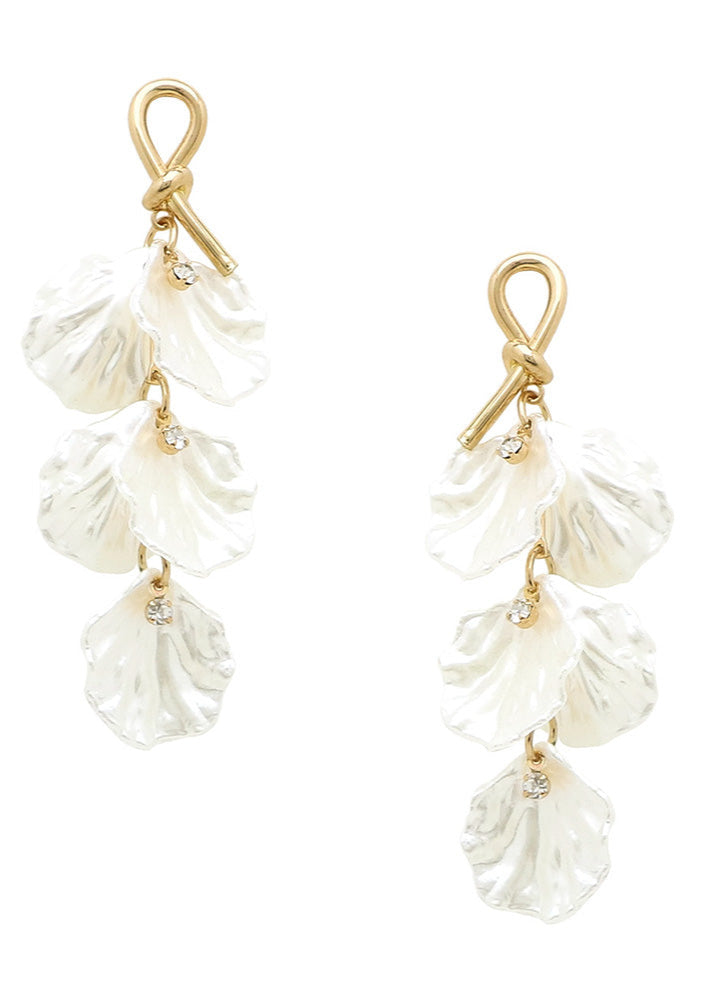 Pair of gold and white shell earrings on a white background