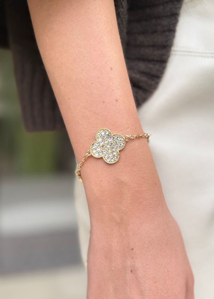 Close-up of a hand wearing a decorative bracelet on a blurred background