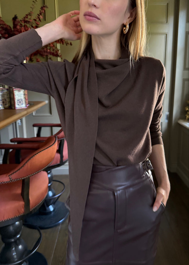 Woman wearing a brown outfit in an indoor setting