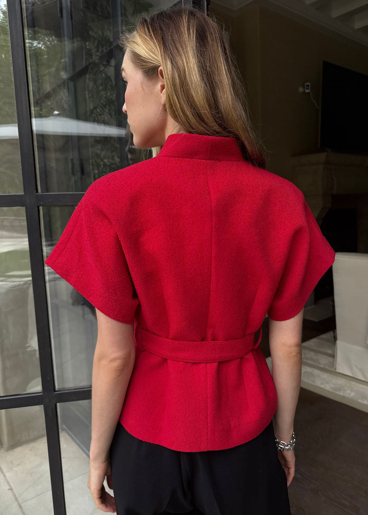 Person wearing a red top in an indoor setting