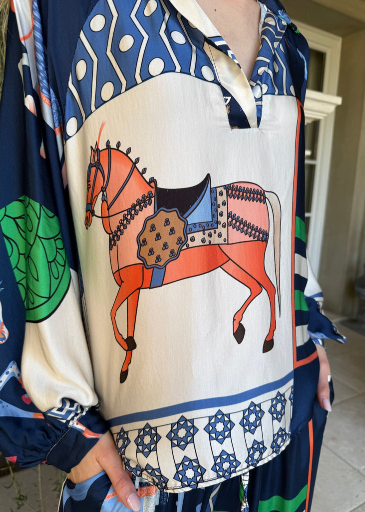 Colorful scarf with a horse design held by a person