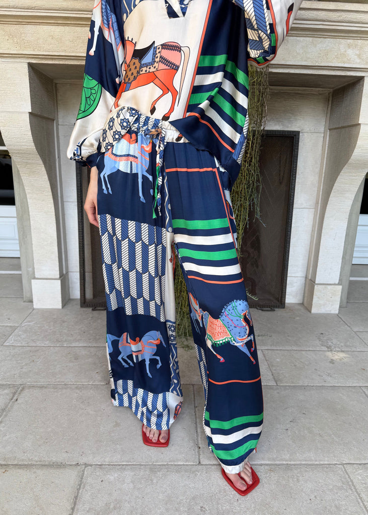 Person wearing a colorful outfit with abstract patterns in an urban setting.