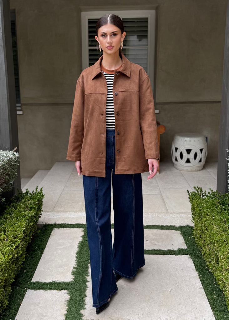 Woman standing on a stone path in a garden setting