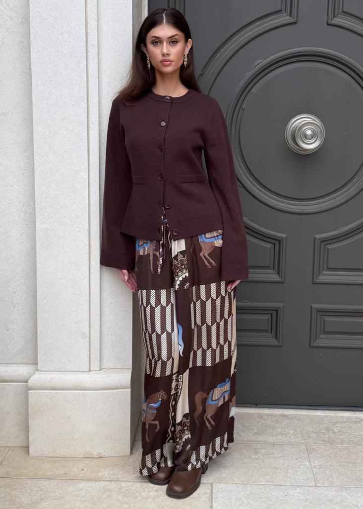 Woman standing in front of a large ornate door