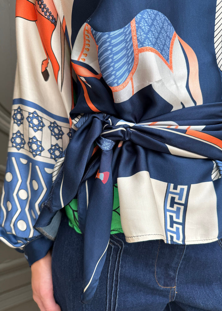 Close-up of a person wearing a colorful patterned scarf with blue, orange, and white design.