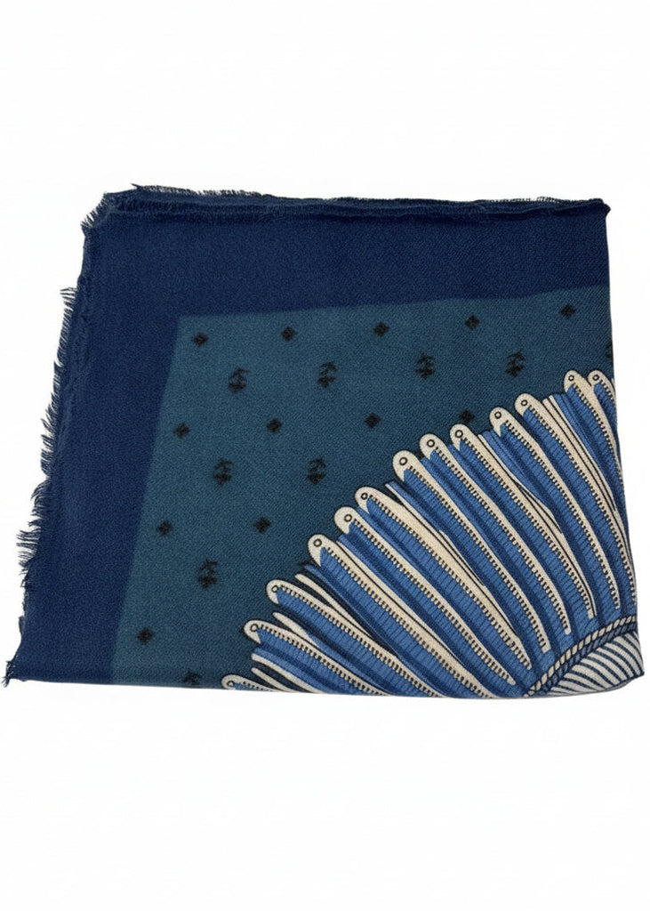 Blue scarf with white patterns on a light gray background