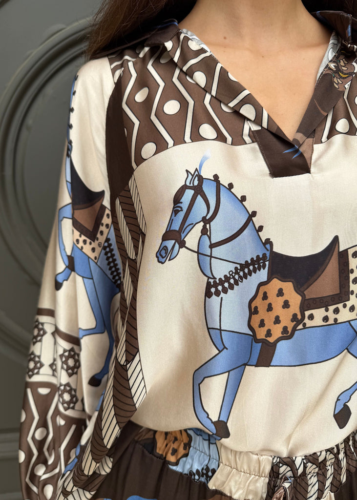 Close-up of a blouse with horse print and patterned collar.