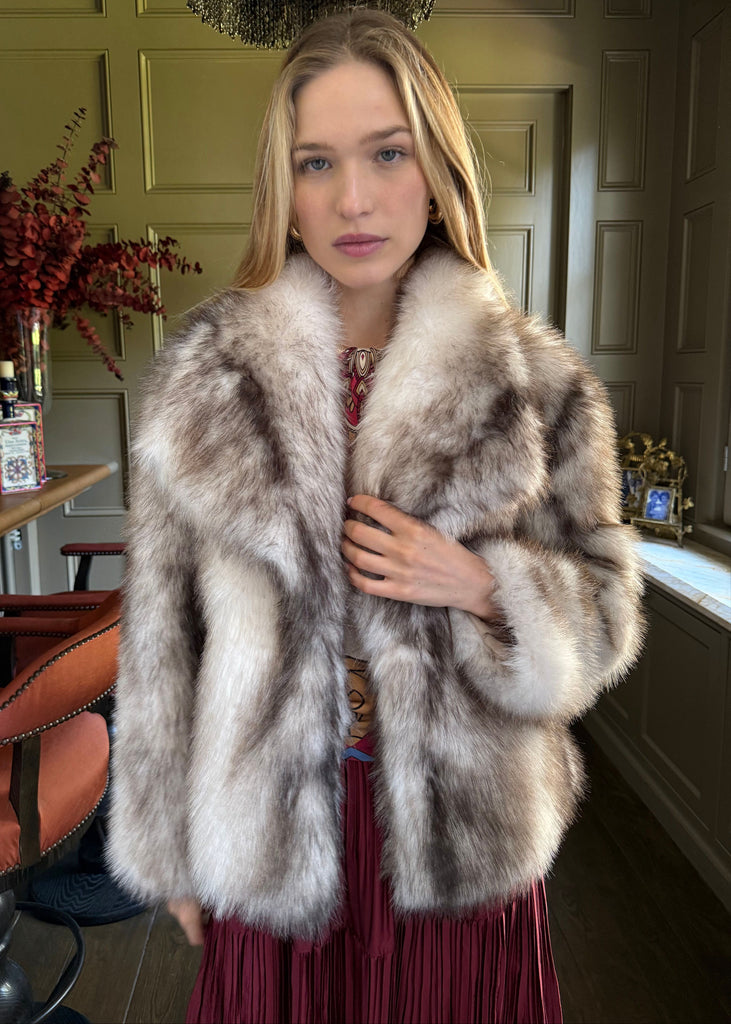 Woman wearing a fur coat in an indoor setting