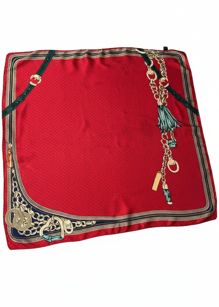 Red fabric with decorative gold and black trim on a white background