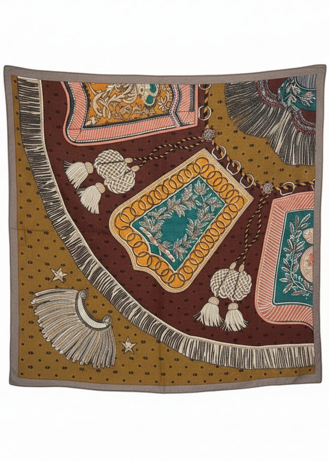 Decorative rug with intricate patterns and tassels on a stand in an indoor setting.