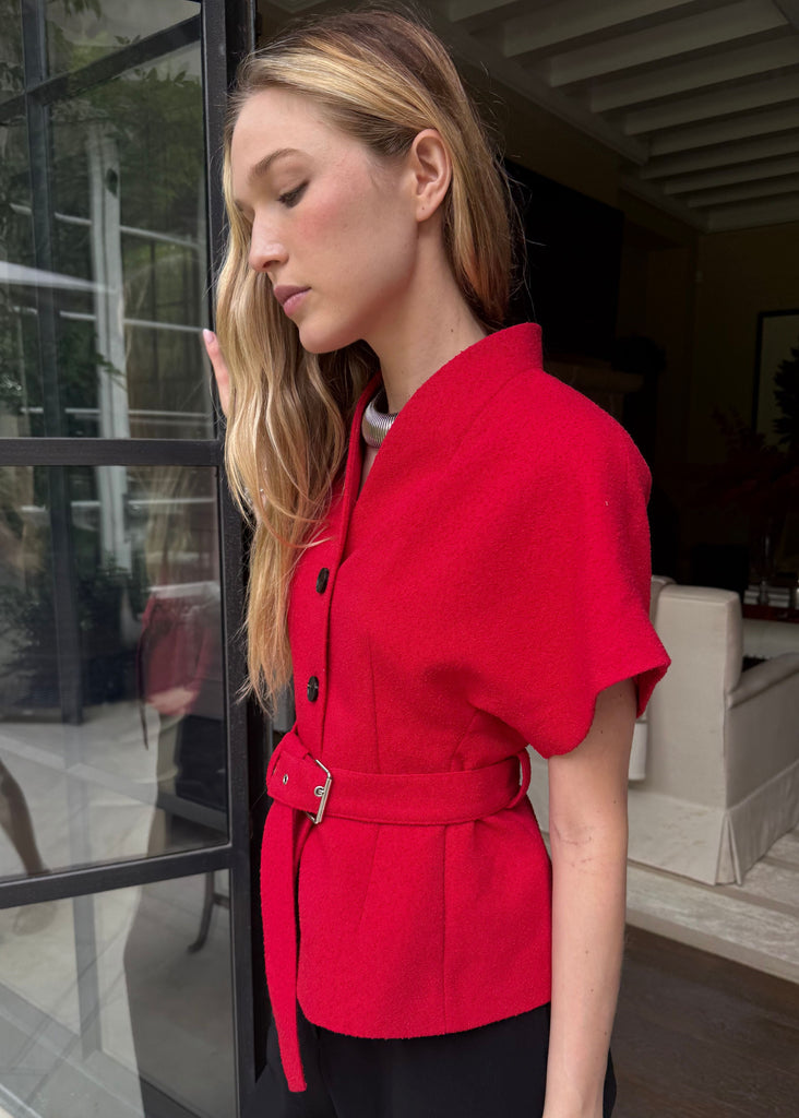 Woman wearing a red jacket in an indoor setting